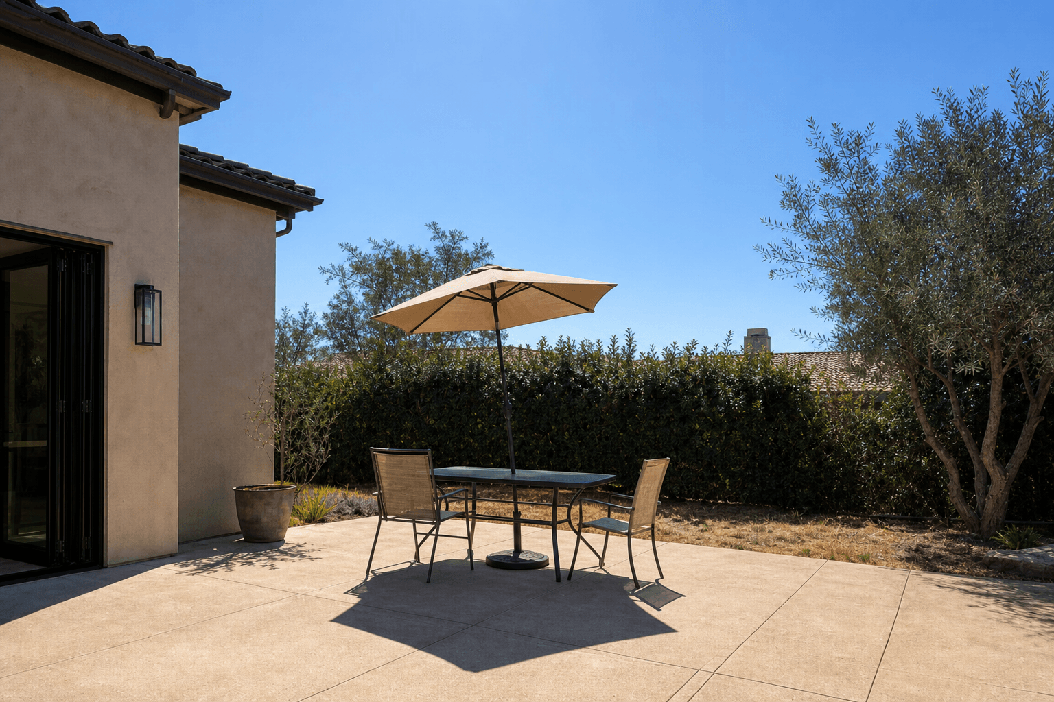 Bare Loomis backyard paver patio with no shade before the pergola